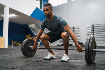 Crossfit athlete doing exercise with a barbell.