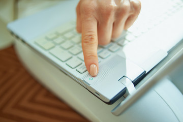 female in house in sunny day switch on laptop