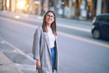 Fototapeta premium Young beautiful woman smiling happy and confident. Standing with smile on face at the town street
