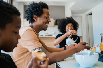 Family having breakfast together at home,