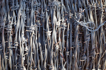 Close up of vertical barb wire clusters