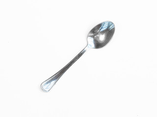 Silver spoon stands vertically with shadow isolated on white.silver spoon isolated on white background