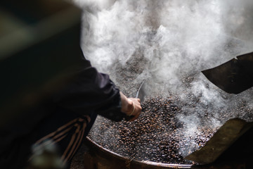 Roasting natural freshly ground coffee beans in the original local equipment components coffee roasting machine homemade of country side farmer Thailand