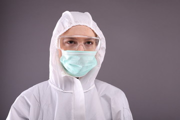Close up of young woman in protective costume, glasses and mask