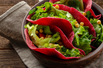 Vegan beetroot taco with salad, avocado, chickpea and vegetables