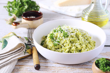 Italian cuisine. Parsley risotto, olive oil and Parmesan cheese