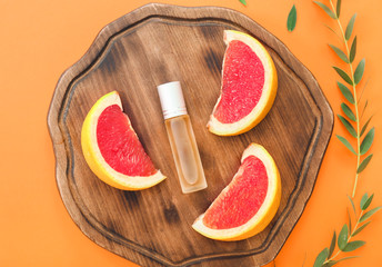 Bottle of citrus roll-on perfume on color background