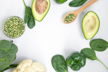 Green vegetables and herbs on a light background.