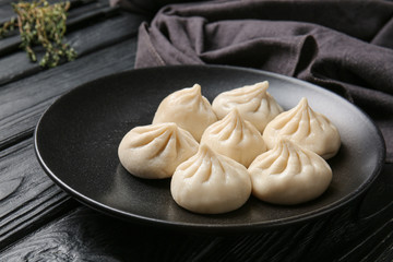 Plate with tasty dumplings on table