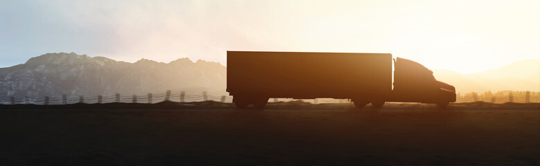 Panoramic - silhouette of truck driving through the mountains