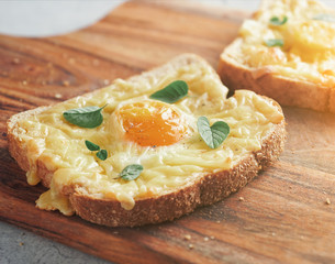 Cheesy Baked Egg Toast on Wooden Cutting Board close up