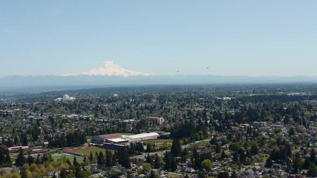 Boeing C17 Aircrafts Flying Over Tacoma, Washington With Snowy Mountain In The Background - aerial shot