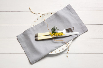 Beautiful table setting with floral decor on wooden background