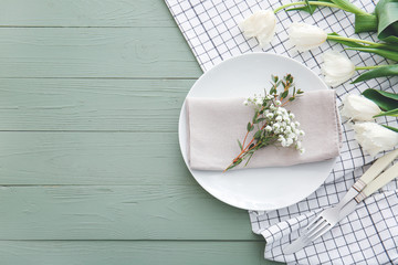 Beautiful table setting with floral decor on wooden background