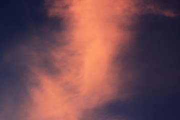 a photo of the sun sinking, leaving orange in the sky and the silhouette of the building in front of it.
