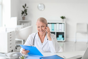 Fototapeta premium Mature female doctor working in clinic
