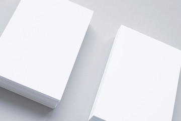 Close view of blank business cards isolated on grey. 3d illustration of vertical stacks.