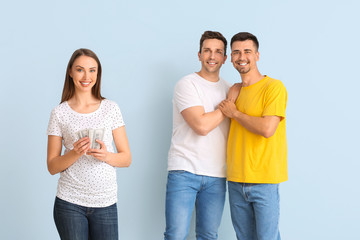 Gay couple and pregnant woman with money on color background