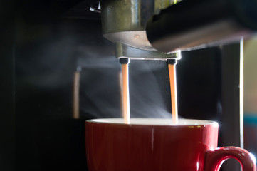 Close-up of espresso pouring to cup from coffee machine. Small business food and beverages. home made coffee and tea.