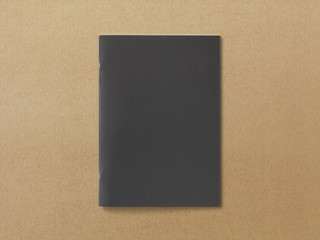 Black Magazine or Brochure on textured paper. Front cover top view. Template concept for your showcase.