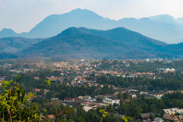 Fototapeta na wymiar View of Luang Prabang town from the top of Mt.Phu Si (or Mt.Phou Si) high hill in the centre of the old town of Luang Prabang in Laos. Luang Prabang is popular UNESCO world heritage sites in Laos.