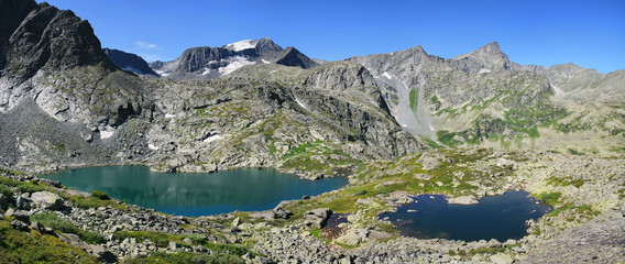 Panoramic mountain view. Rocky mountain slopes, two lakes. Traveling in the mountains, hiking.