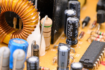 Old vintage printed circuit board with electronic components. Electronic Coil in the foreground....