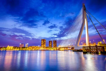 Wall murals Erasmus Bridge Dutch Travel Destination. View of Renowned Erasmusbrug (Swan Bridge) in  Rotterdam in front of Port and Harbour. Picture Made At Dusk.