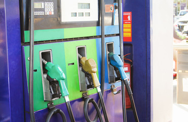 Horizontal shot of some fuel pumps at a gas station.