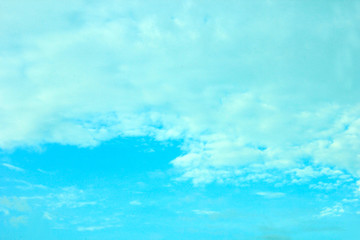 Fototapeta na wymiar a photo of a cloud of clouds in the bright cyan-colored sky in the morning, looking very beautiful and charming.