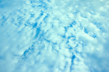 a photo of a cloud in the bright blue sky in the morning, looking very beautiful and charming.