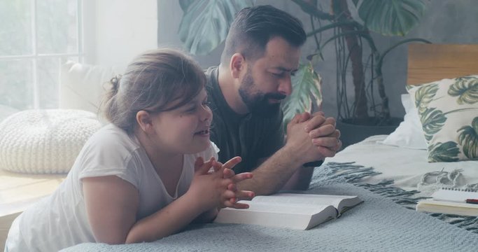 Father and daughter praying together