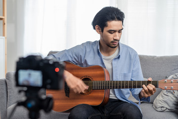 Asian male vlog influencer performancing music and singing show to streaming digital internet...