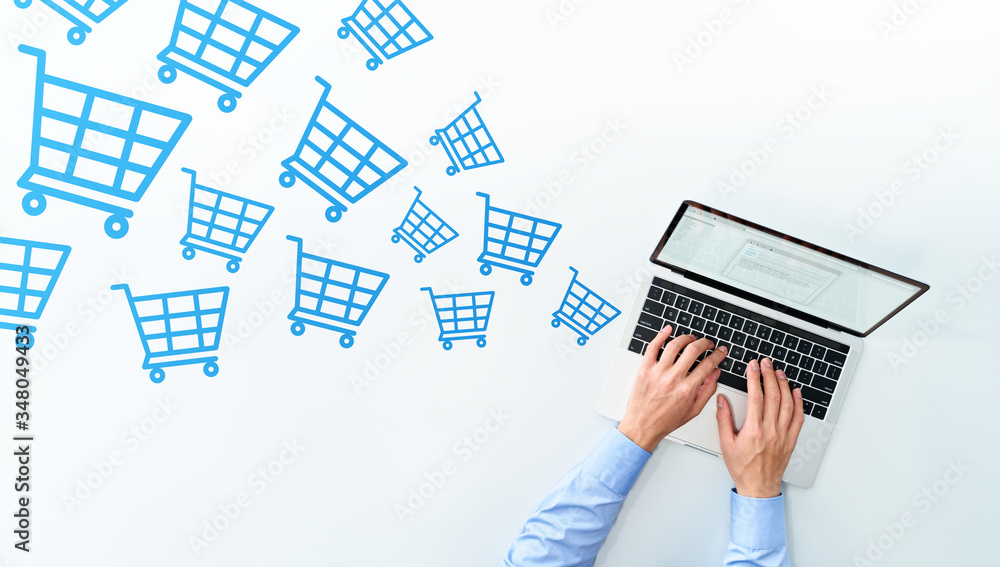 Aufkleber e-commerce concept. receiving rush of orders. top view of using laptop. many blue shopping cart icon