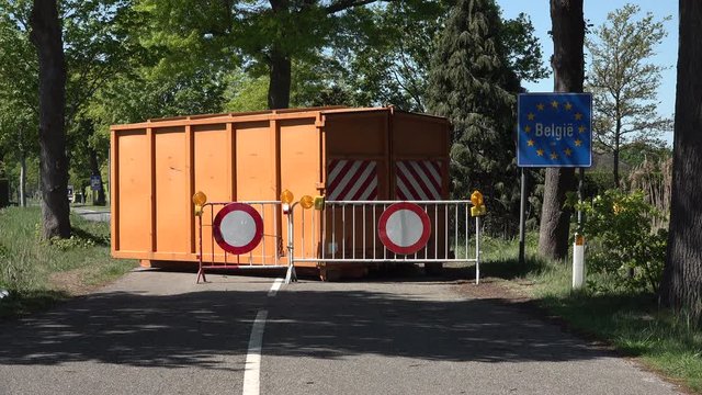 Unique situation at the border between Belgium and the Netherlands, container blocks road in small village due to coronavirus Covid-19 travel restrictions in Europe
