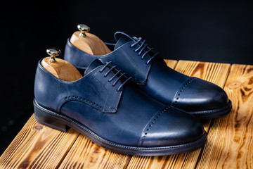 stylish leather blue shoes against a dark background
