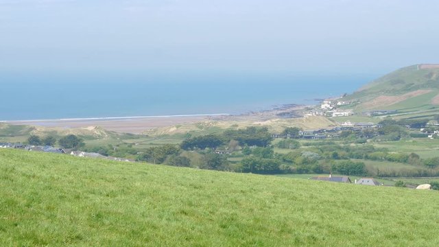 Stunning Nature Scenery Of Bright Blue Sea Around The Lush Island In Croyde, UK - wide shot