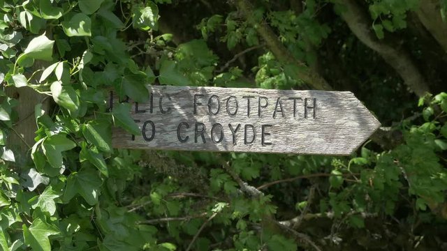A Wooden Arrow Sign Pointing The Direction To The Public Footpath To Croyde, UK - closeup shot
