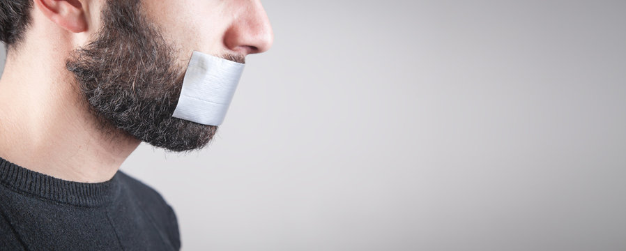 Caucasian Man With Tape On Mouth. Censorship