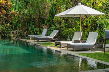Chairs and umbrella by pool at resort