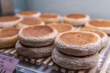 Whole wheat flat pita bread on wooden tray