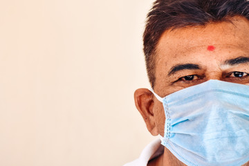 Portrait of an Indian man wearing medical mask during the coronavirus pandemic