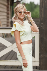 Fototapeta premium Stylish bridesmaid in yellow dress posing