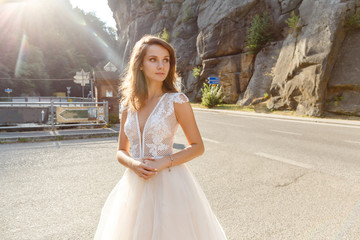 Fototapeta na wymiar Young stylish bride posing in the mountains
