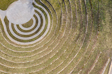 Fototapeta na wymiar grass and stone steps of outdoor amphitheater at sunny day. aerial top view