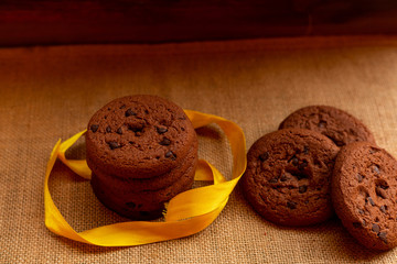 Baked chocolate chip cookies on an artistic background.