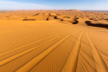 Desert Sahara with beautiful lines and colors at sunrise. Merzouga, Morocco