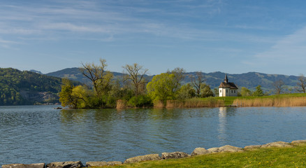 The historical St. Meinrad Chappel situated in an idyllic peninsula on the shores of the Upper Zurich Lake near Bollingen, st. Gallen, Switzerland