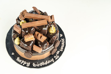 sweet triple chocolate cake with decoration on white background