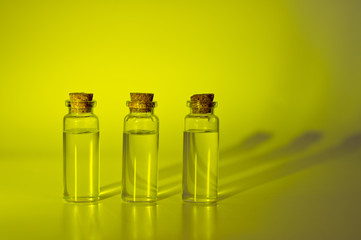 Three glass corked bottles filled with liquid. Background for science and medicine. Virus vaccine.